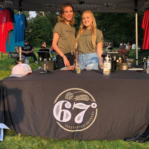 67 Degrees Brewing Staff working a beer & merch table