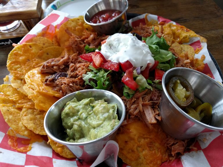 Burnt Timber Brewing pulled pork nachos with salsa, sour cream, and guacamole.