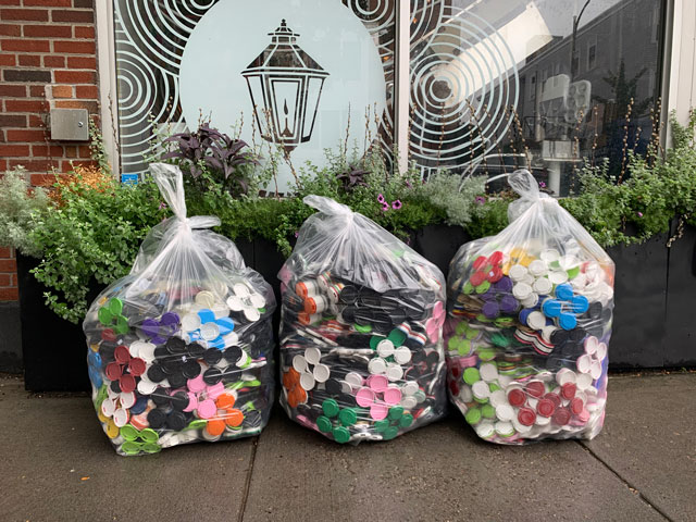 A collection of used craft beer can carriers in bags at Lamplighter Brewing Company in Cambridge, MA