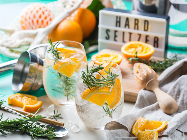 Homemade hard seltzer freshly poured into stemless wine glasses