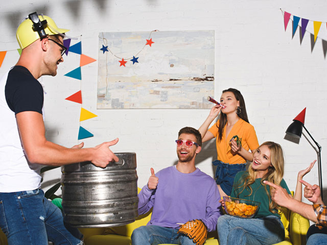 A man bringing a fresh, untapped keg of beer to a party with friends.