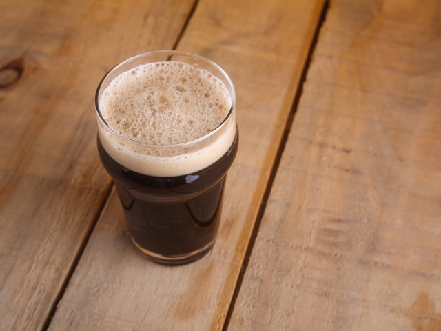 A Nonic Pint Glass filled with a British pub beer